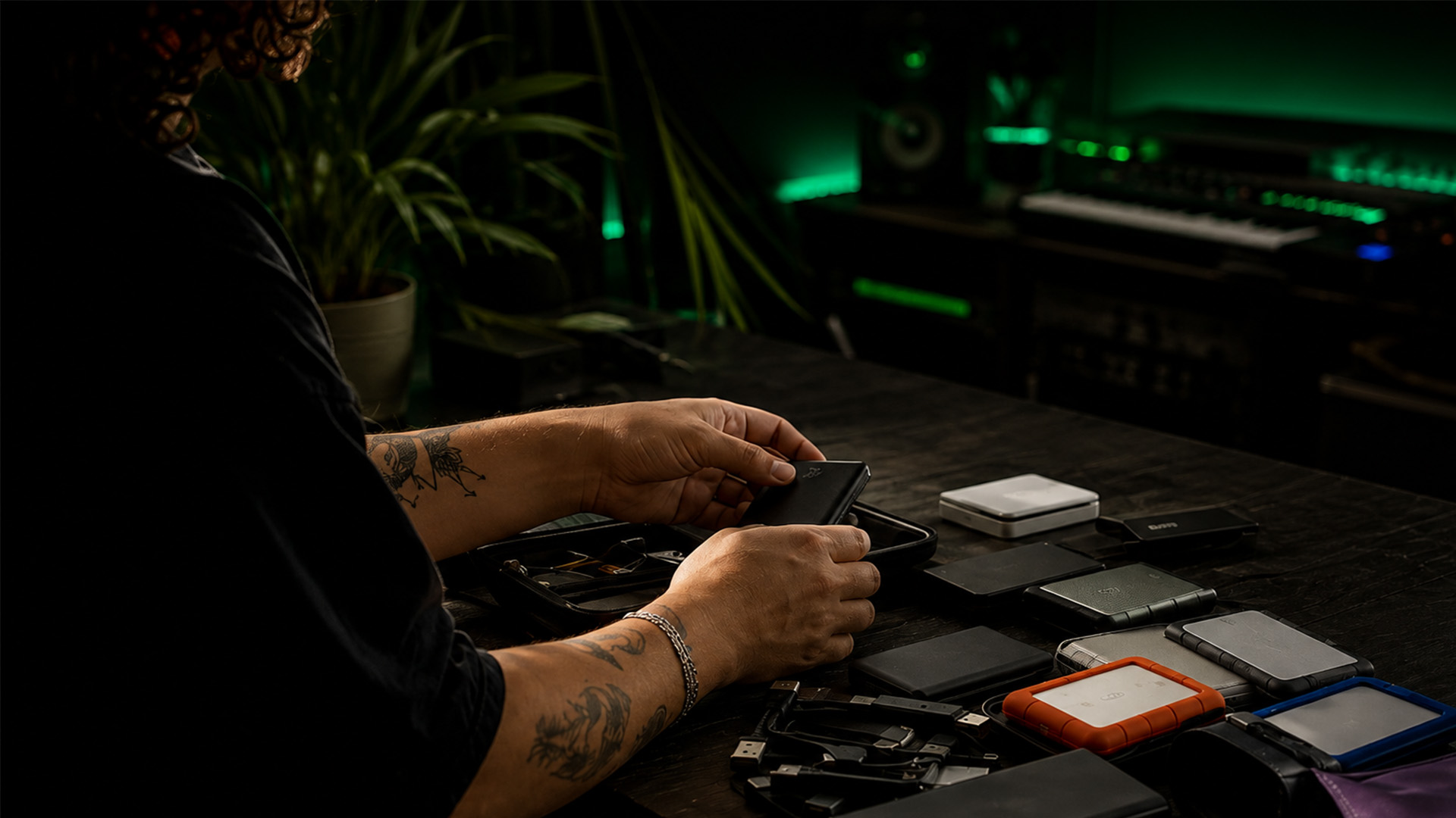 Hands organizing digital storage devices