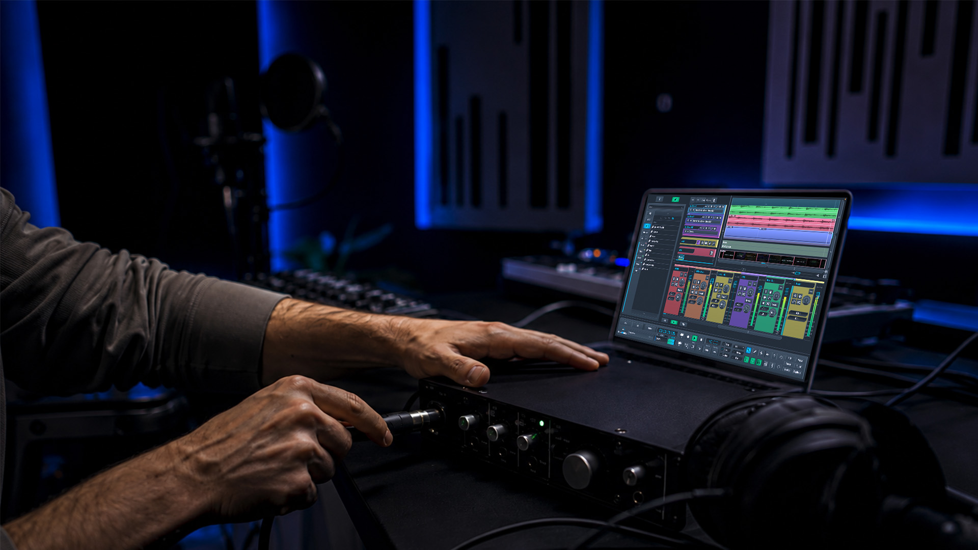 Hands connecting audio cables for a remote session