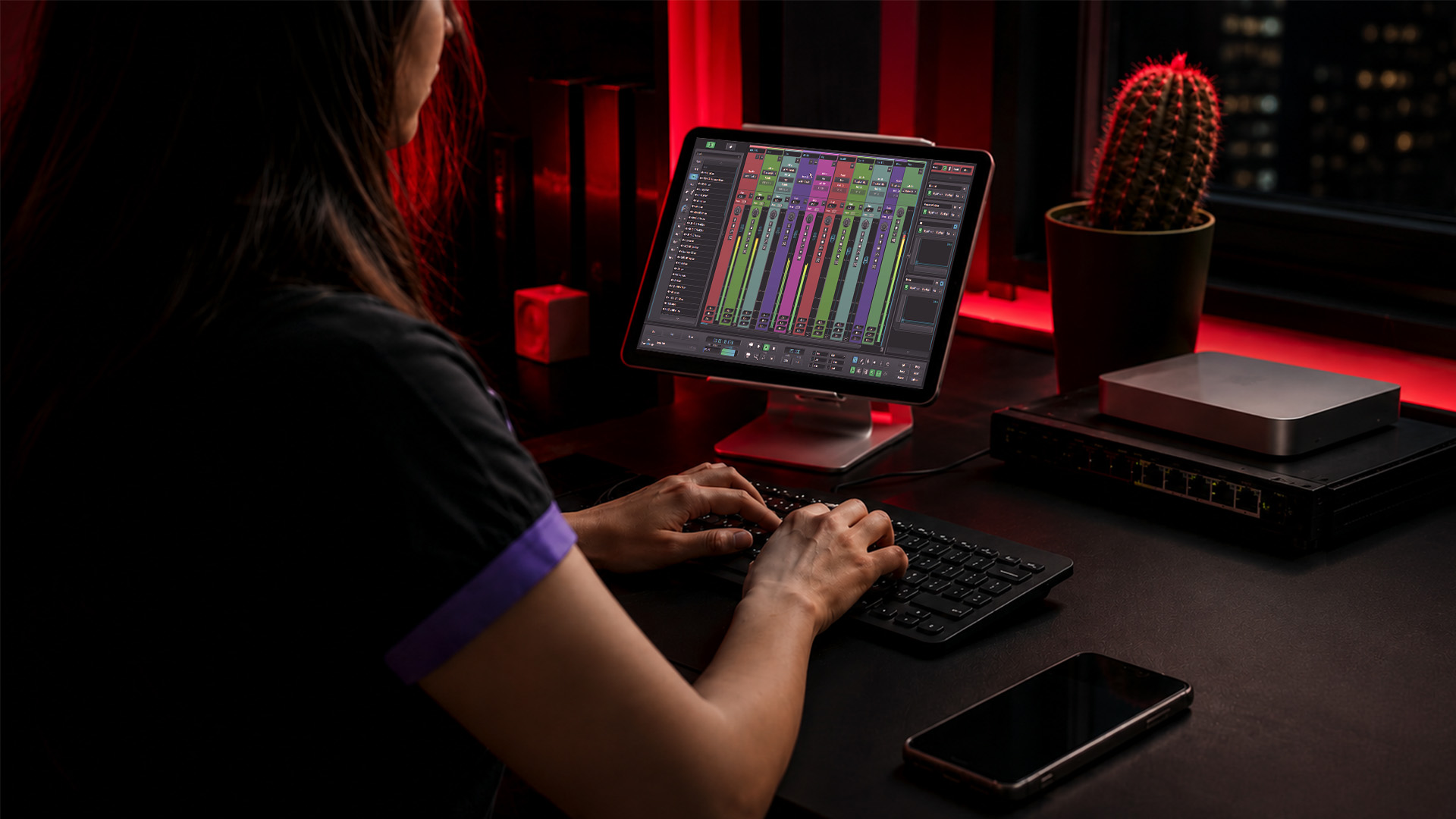 Hands managing a VPS and a domain setup on a desk
