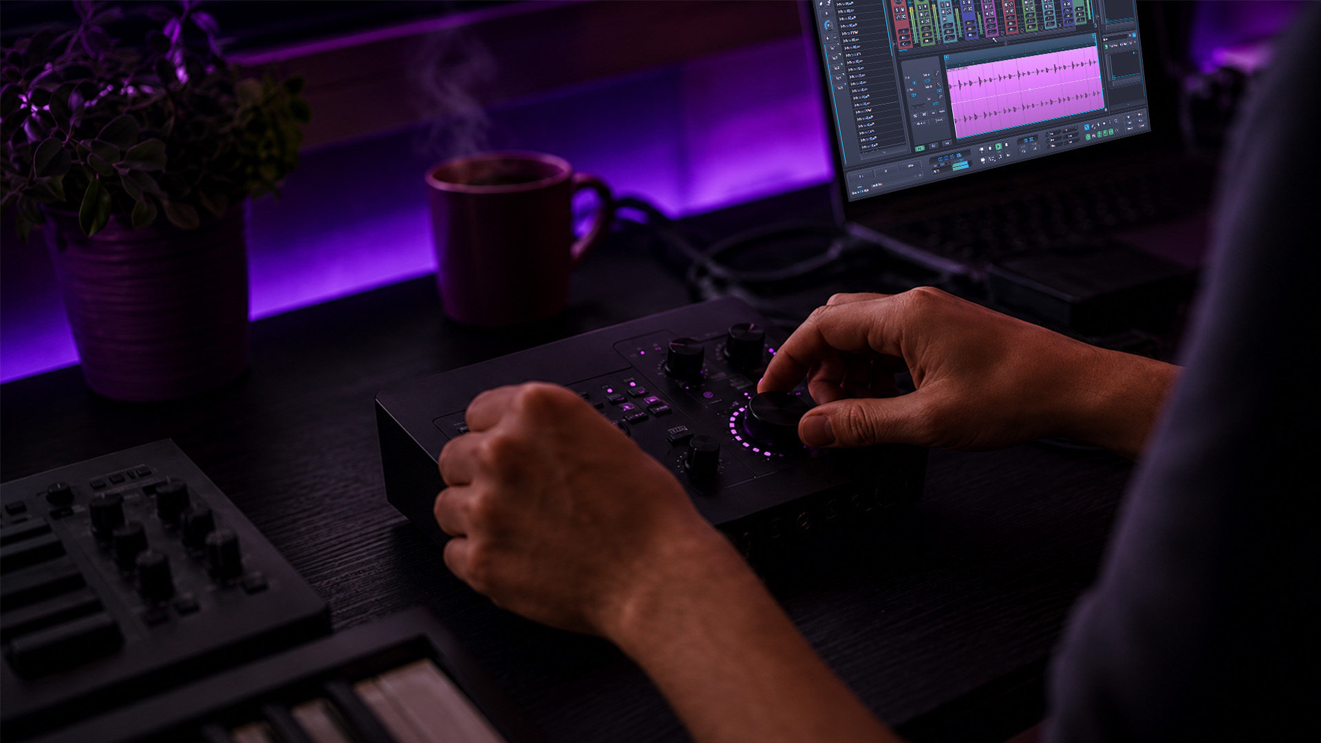 A producer's hands adjusting mixing console knobs