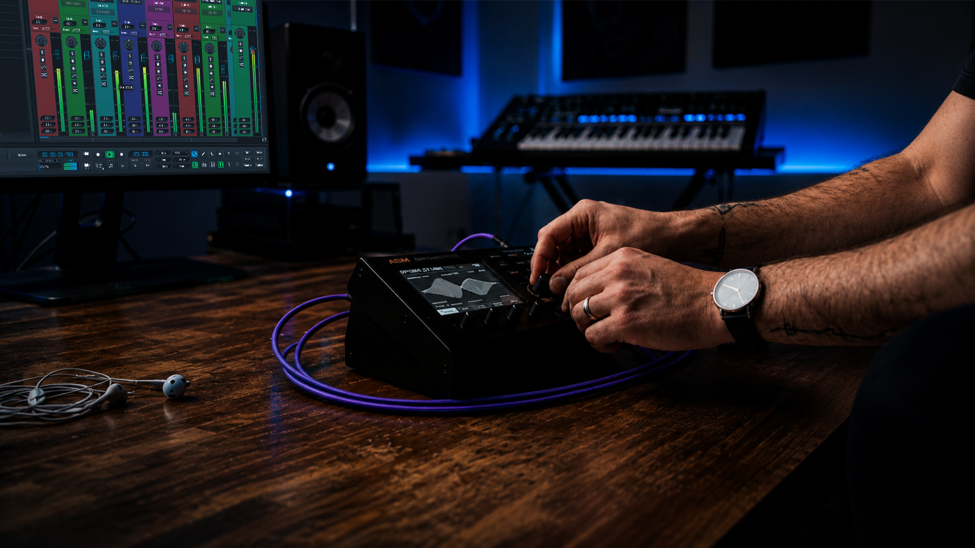 Hands tweaking synthesizer controls on coffee table