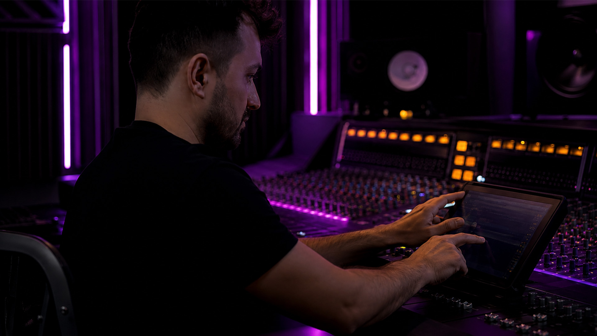 An audio engineer’s hands adjusting a mixing console