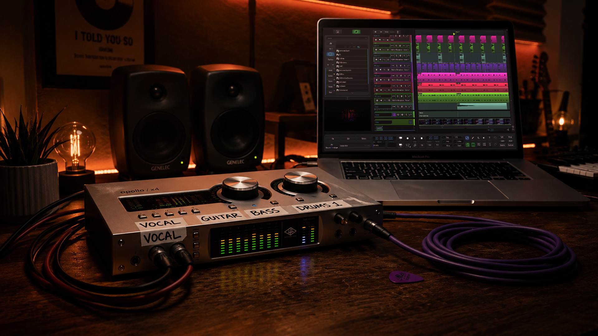 A close-up audio interface with a laptop, cables and notes