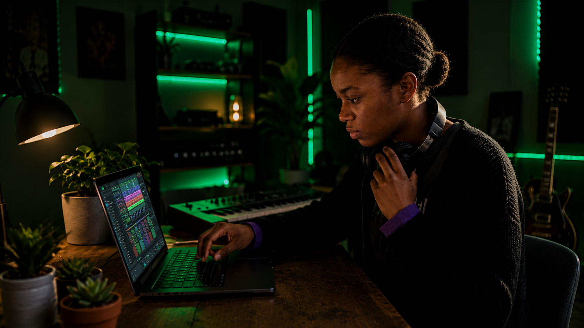 A producer adjusting audio plugin controls in a home studio