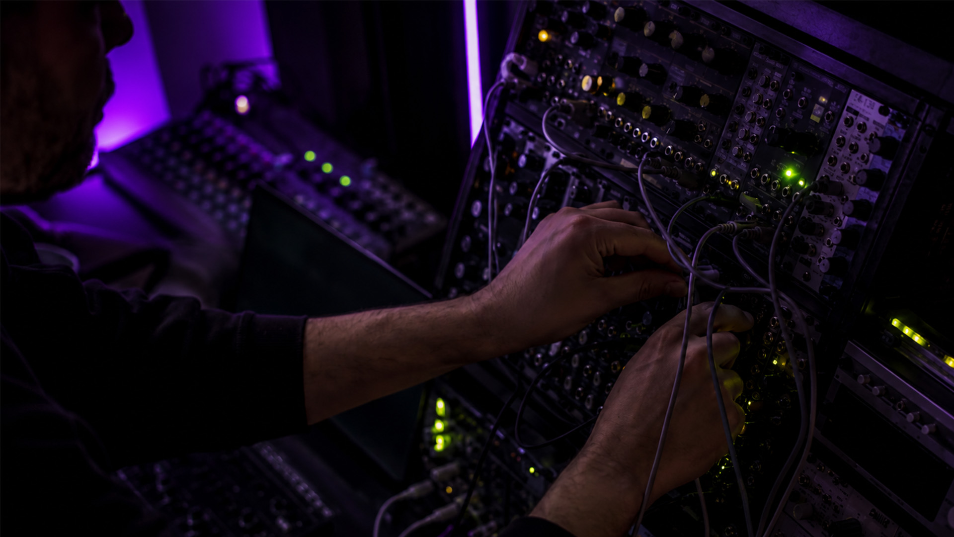 Hands swapping MIDI cables during troubleshooting
