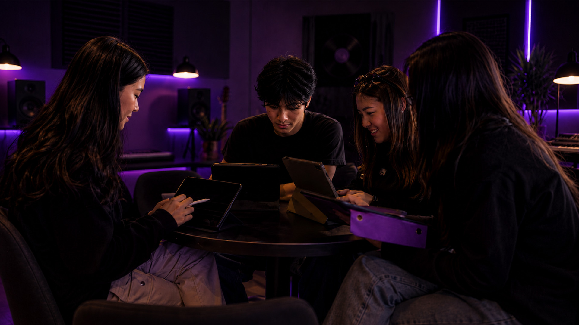 Hands using a tablet with an AI music app in a classroom