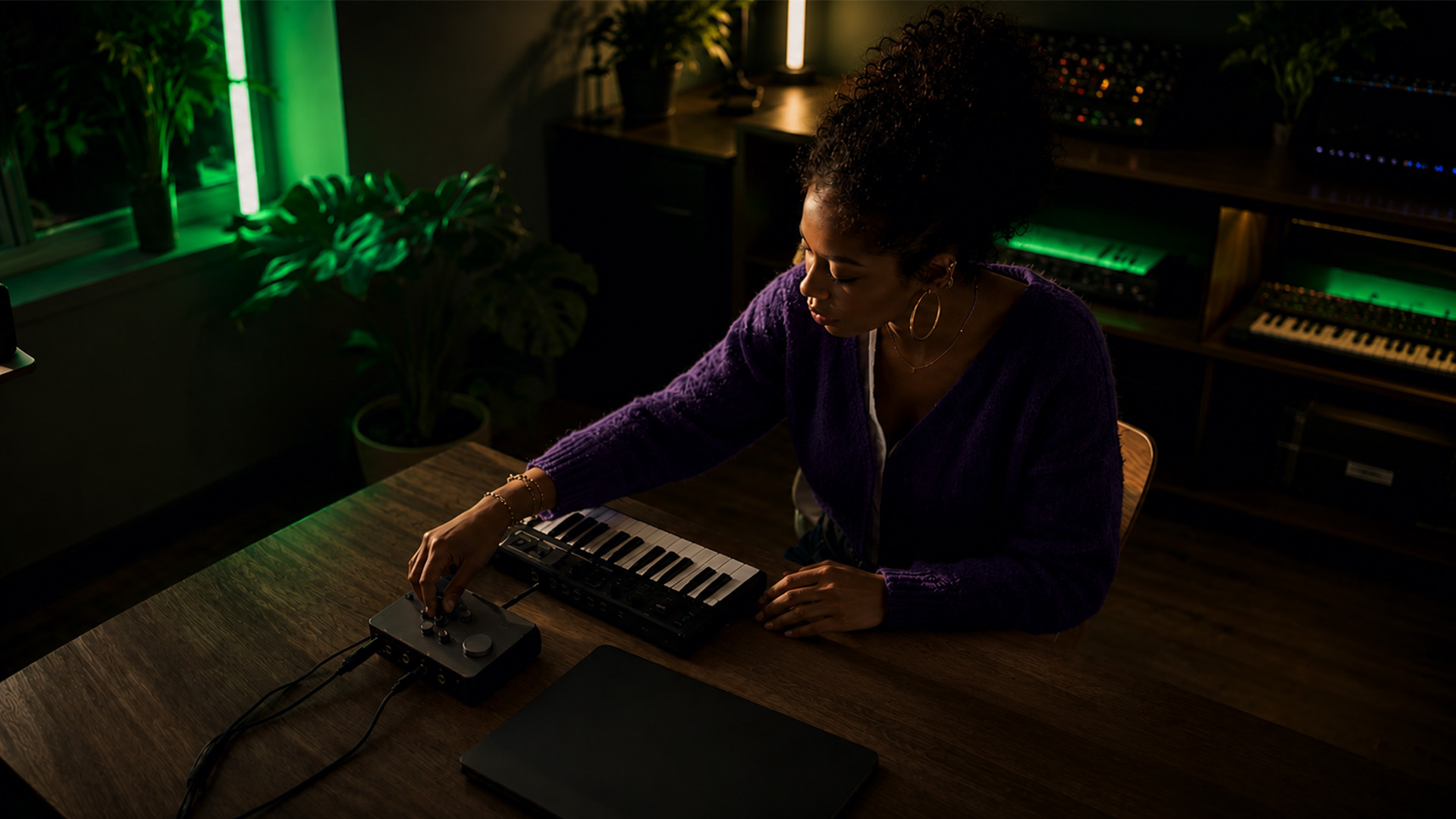 A home music producer working at laptop desk