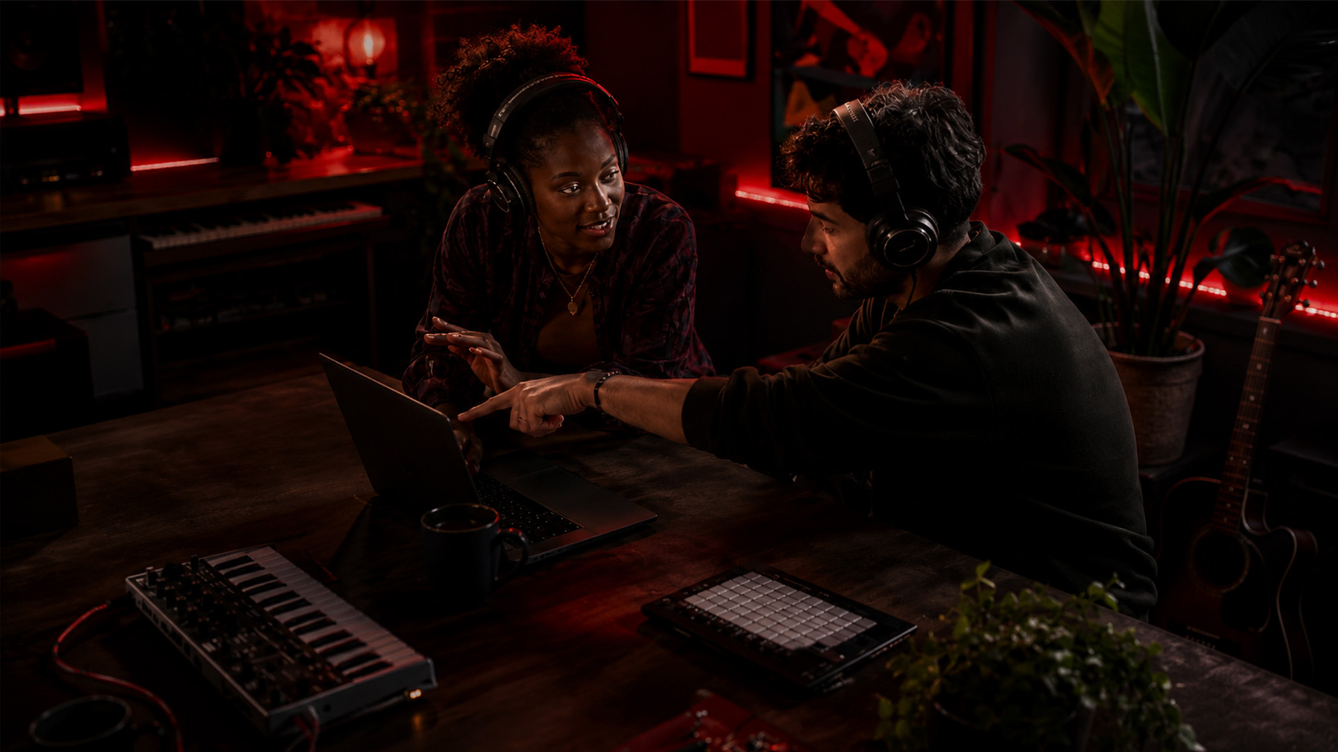 Two collaborators discussing music software workflow