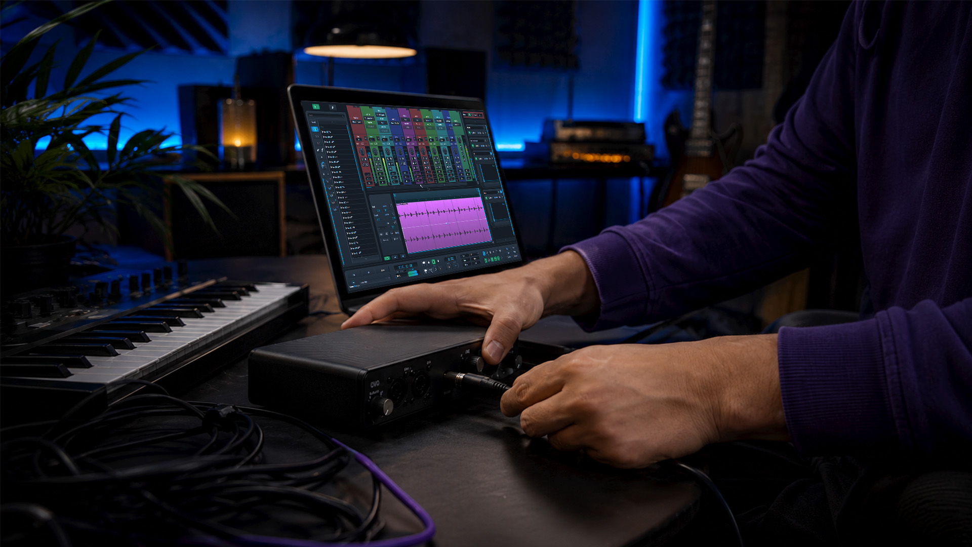 Hands connecting an audio interface hardware setup